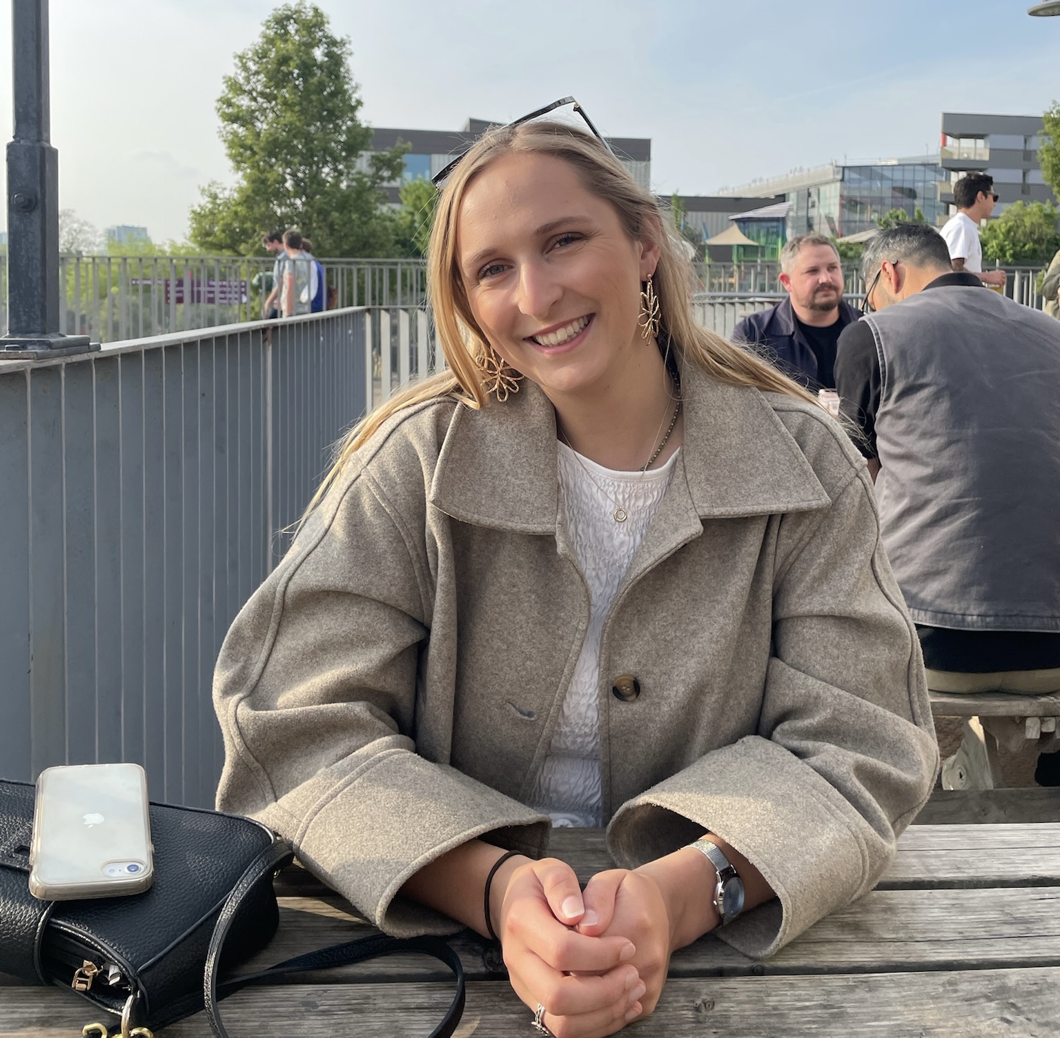 Katie Merrin smiling at an outdoor table